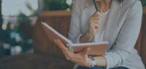 Woman business owner holding notebook and pen